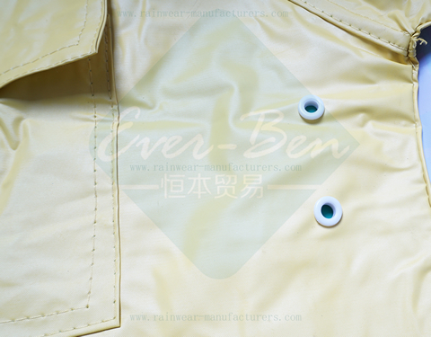 Yellow reversible plastic rain jacket vent holes